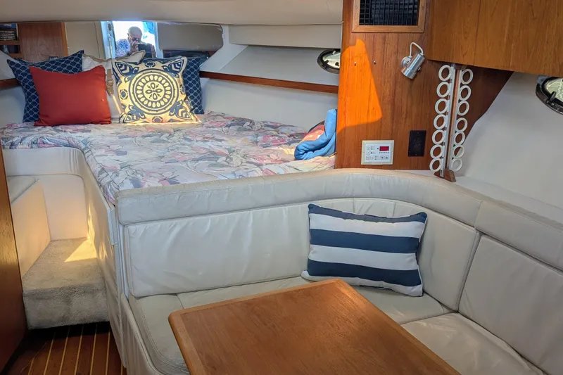 Slide: The Image of Interior of a 1995 Tiara Yachts 3100 Open with cozy seating and bed area. - 27