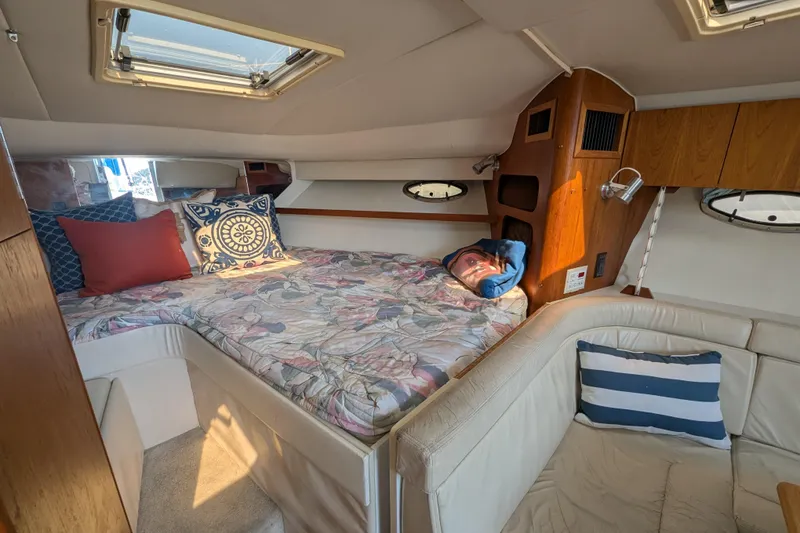 Slide: The Image of 1995 Tiara Yachts 3100 Open cabin interior with cozy bed and seating area. - 29