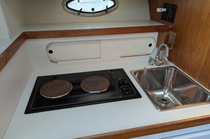 Slide: The Image of 1995 Tiara Yachts 3100 Open galley with stove and sink. - 33