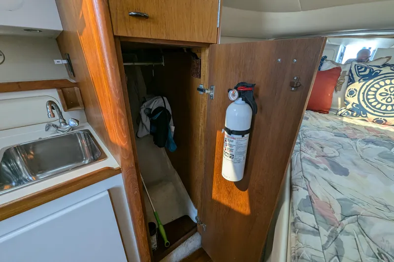 Slide: The Image of 1995 Tiara 3100 yacht interior with sink, closet, and bed. - 37