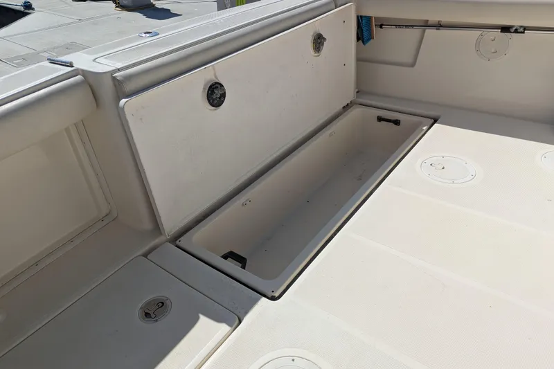 Slide: The Image of 1995 Tiara Yachts Tiara 3100 deck with open storage compartment. - 40