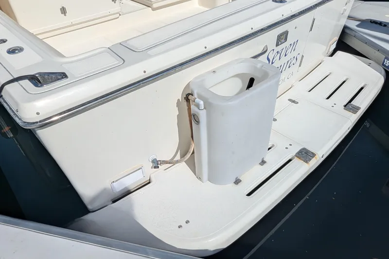 Slide: The Image of 1995 Tiara Yachts 3100 swim platform with storage compartment and dockside view. - 44