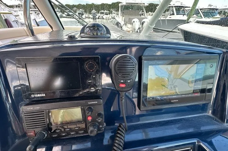 Slide: The Image of 2016 Pursuit DC 265 Dual Console dashboard with Yamaha and Garmin navigation systems. - 10