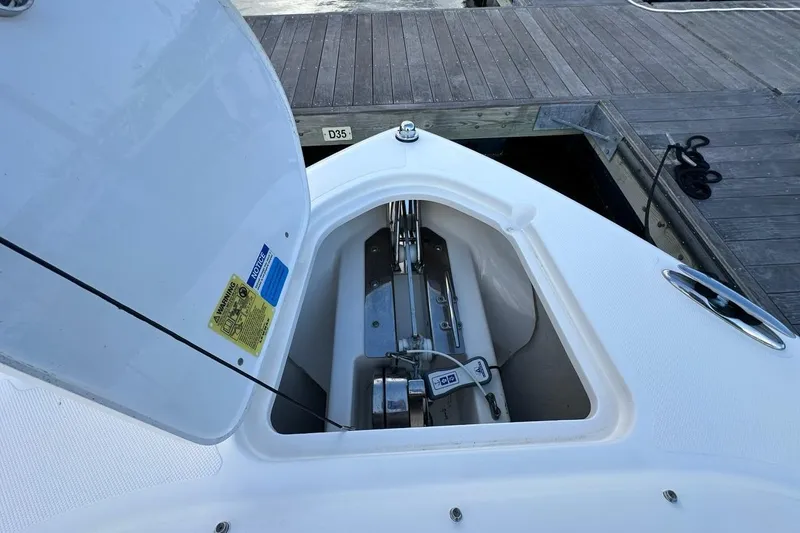Slide: The Image of 2016 Pursuit DC 265 Dual Console boat anchor compartment at dock. - 27