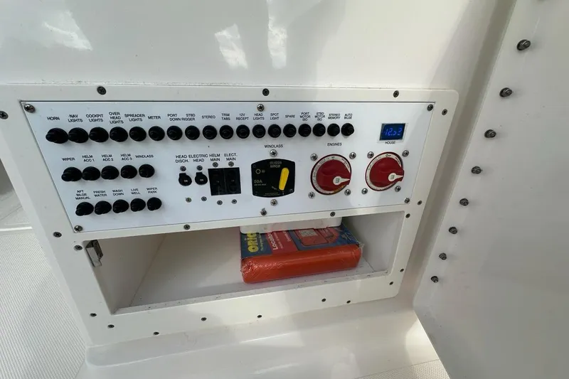 Slide: The Image of Control panel of a 2016 Pursuit DC 265 Dual Console boat with switches and gauges. - 29