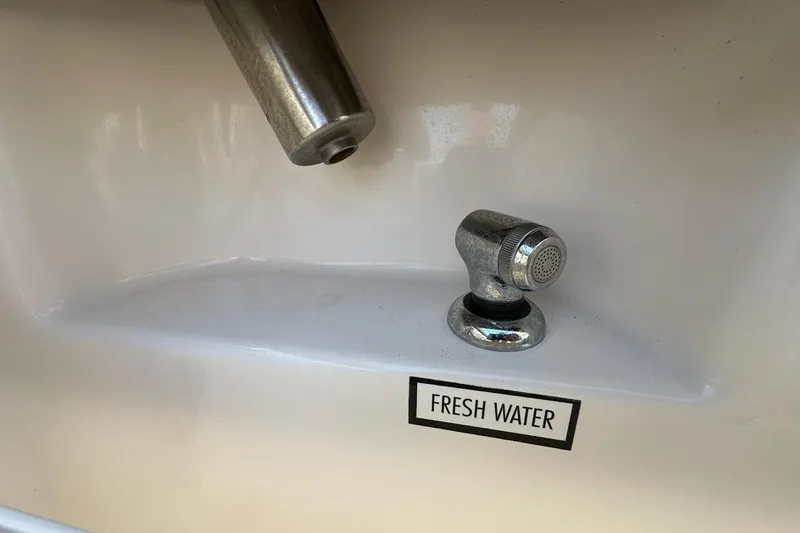 Slide: The Image of Fresh water outlet on 2016 Pursuit DC 265 Dual Console boat. - 30