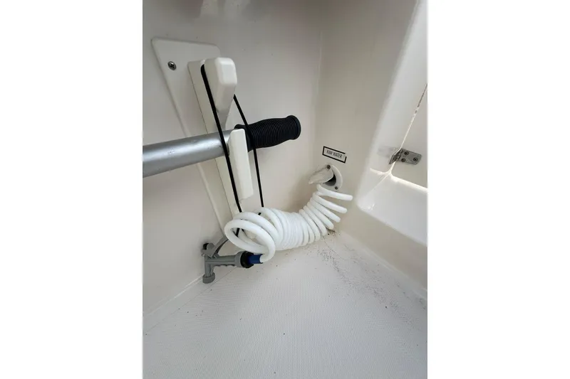 Slide: The Image of Coiled hose and fittings on 2016 Pursuit DC 265 Dual Console boat. - 31