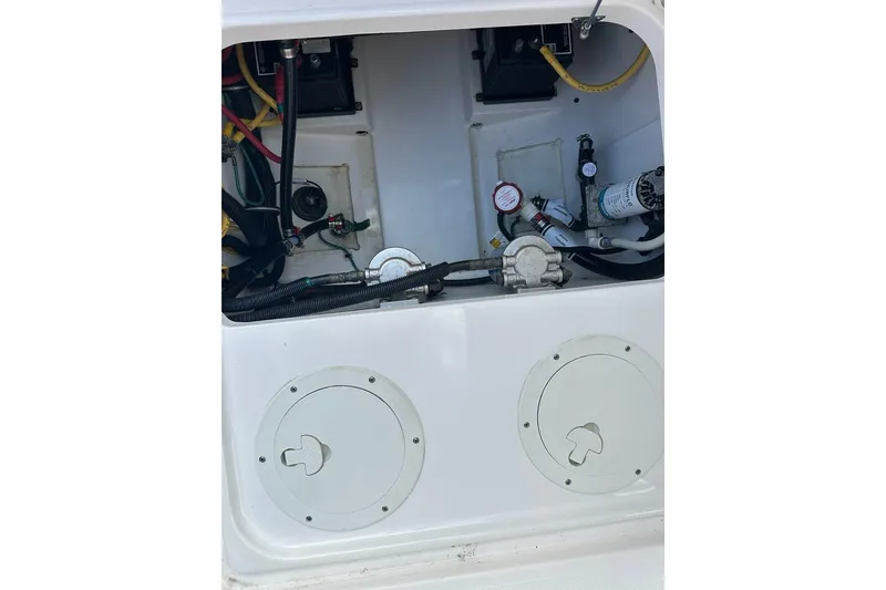Slide: The Image of 2016 Pursuit DC 265 Dual Console boat interior wiring and components. - 33