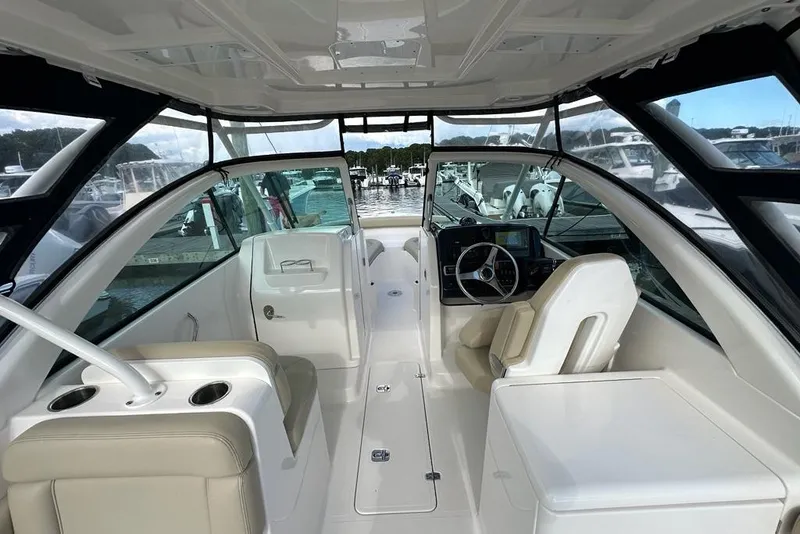 Slide: The Image of 2016 Pursuit DC 265 Dual Console boat interior with helm and seating. - 6