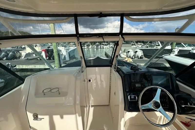 Slide: The Image of Interior view of 2016 Pursuit DC 265 Dual Console boat at marina. - 7