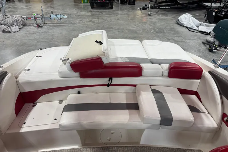 Slide: The Image of 2012 Rinker Captiva 216 BR boat interior with red and white seating. - 11