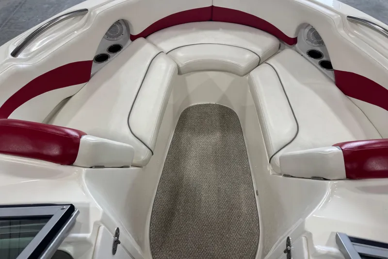 Slide: The Image of 2012 Rinker Captiva 216 BR boat interior with red and white seating. - 8