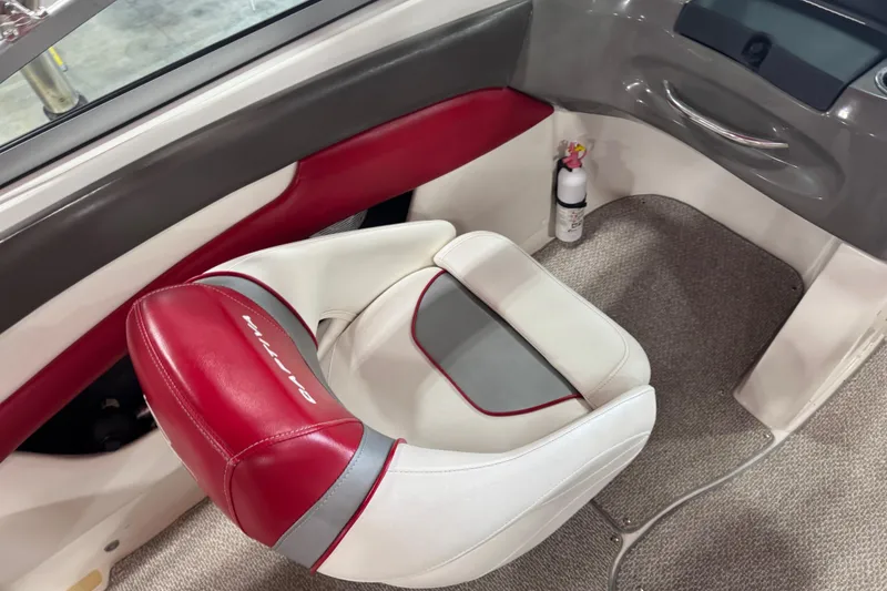 Slide: The Image of 2012 Rinker Captiva 216 BR boat interior with red and white seating. - 9