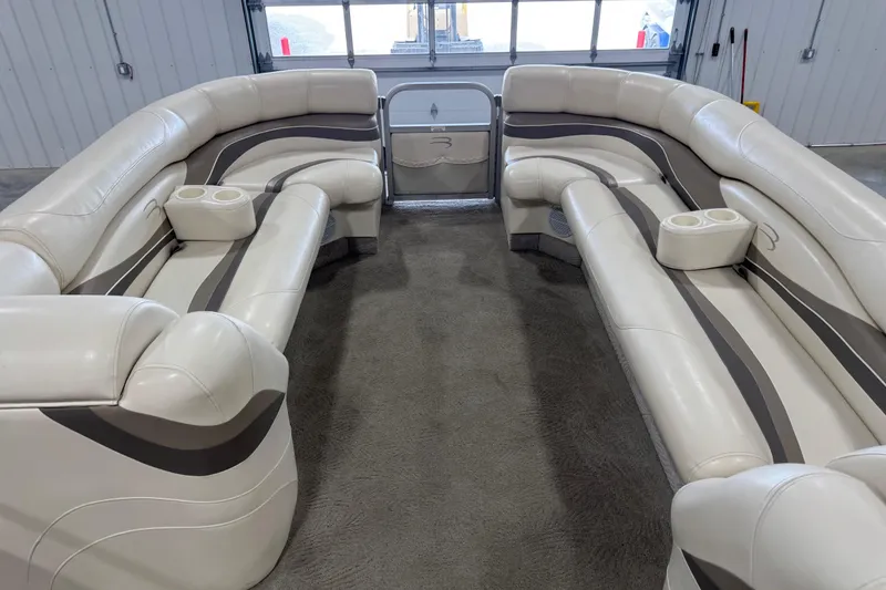 Slide: The Image of Interior of a 2006 Bennington 2575 RL I/O boat with beige seating and cup holders. - 10