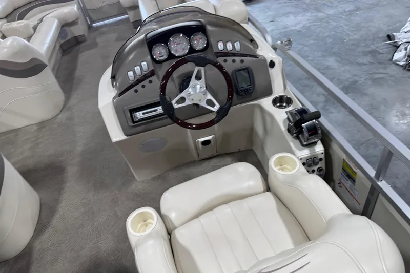 Slide: The Image of 2006 Bennington 2575 RL I/O boat interior with steering console and seating. - 11