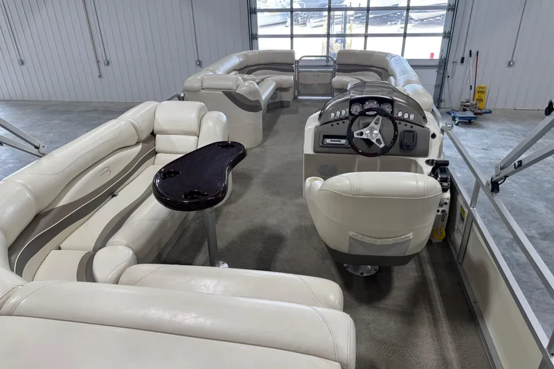 Slide: The Image of 2006 Bennington 2575 RL I/O pontoon boat interior with plush seating and helm. - 12