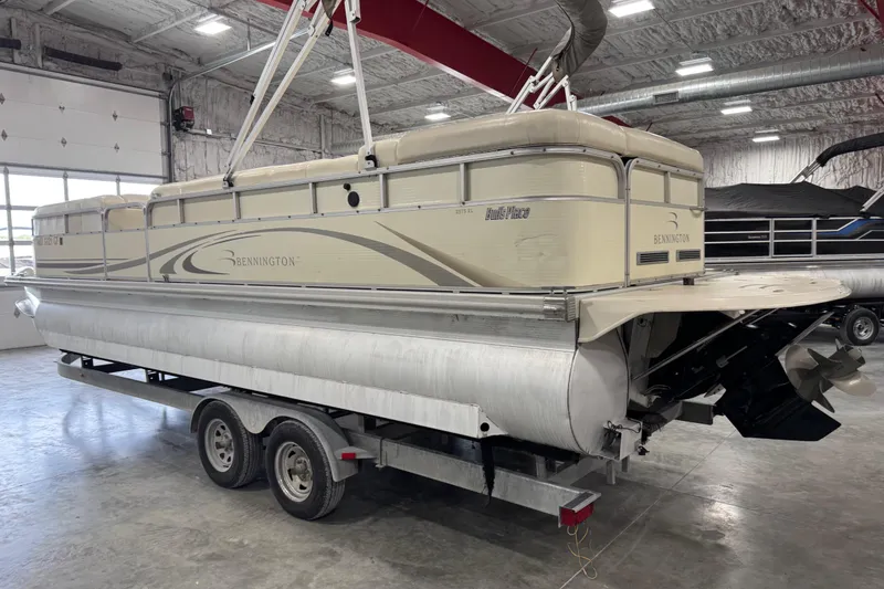 Slide: The Image of 2006 Bennington 2575 RL I/O pontoon boat on trailer in indoor storage facility. - 3