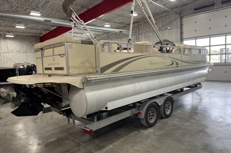 Slide: The Image of 2006 Bennington 2575 RL I/O pontoon boat on trailer in indoor storage. - 4
