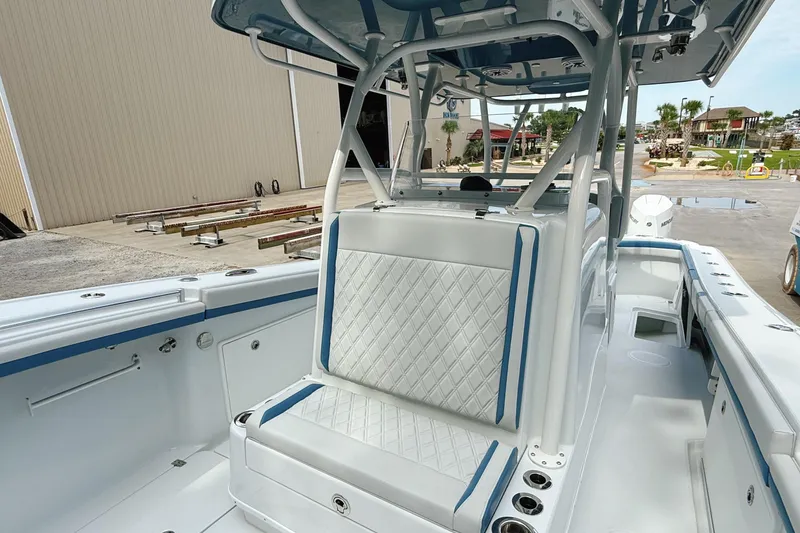 Slide: The Image of 2024 Yellowfin 34 Offshore boat interior with cushioned seating and armrests. - 14