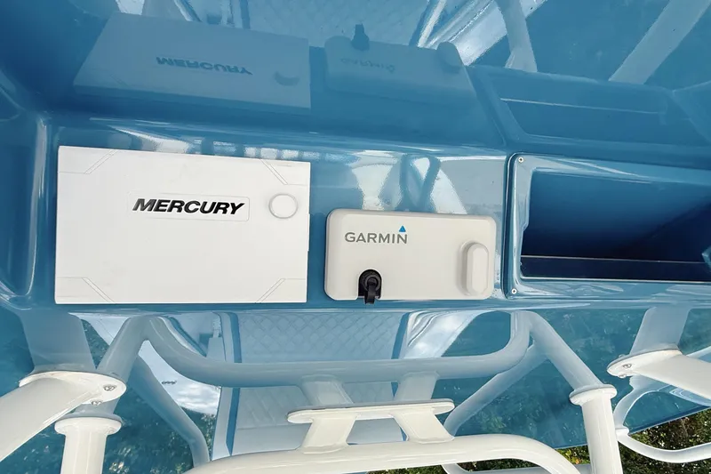 Slide: The Image of 2024 Yellowfin 34 Offshore boat dashboard with dual Garmin displays and control panel. - 19