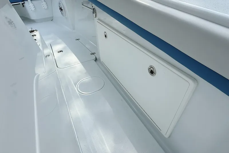 Slide: The Image of 2024 Yellowfin 34 Offshore boat control panel with start-stop button and lever. - 21