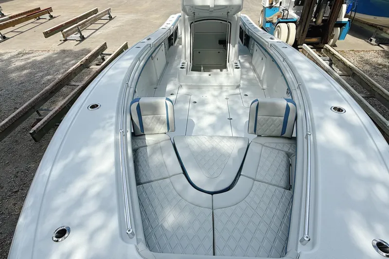 Slide: The Image of 2024 Yellowfin 34 Offshore boat interior, featuring sleek white deck and storage compartment. - 24