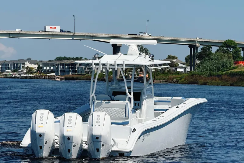 Slide: The Image of 2024 Yellowfin 34 Offshore boat cockpit with steering wheel and dual screens. - 28