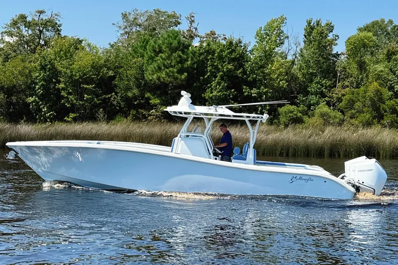 Slide: The Image of 2024 Yellowfin 34 Offshore boat docked, showcasing sleek design and spacious deck. - 30