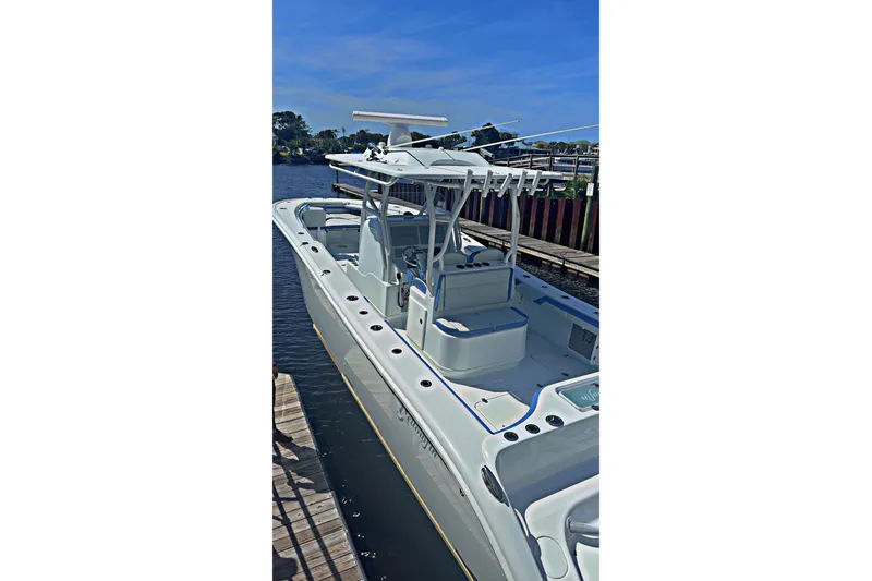 Slide: The Image of 2024 Yellowfin 34 Offshore boat docked, featuring sleek design and modern seating. - 31
