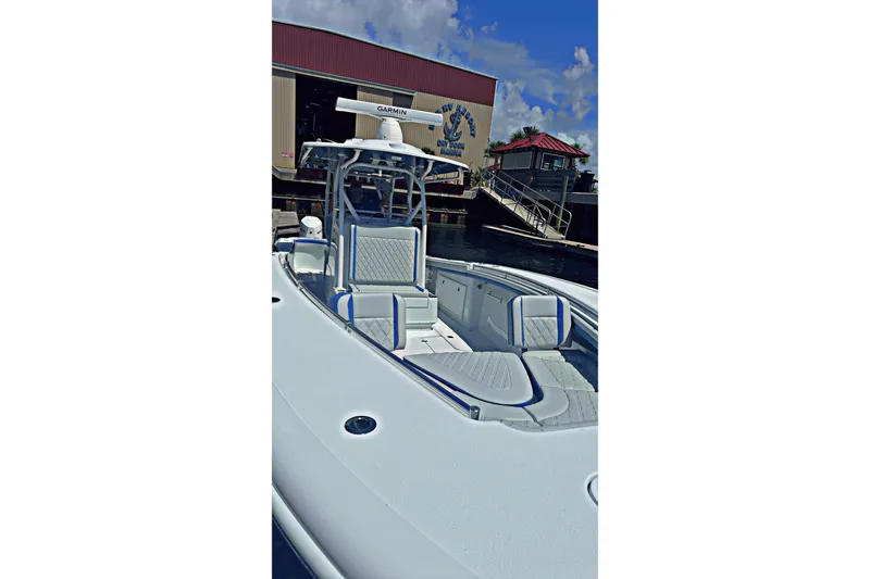 Slide: The Image of 2024 Yellowfin 34 Offshore boat docked with triple outboard engines. - 32