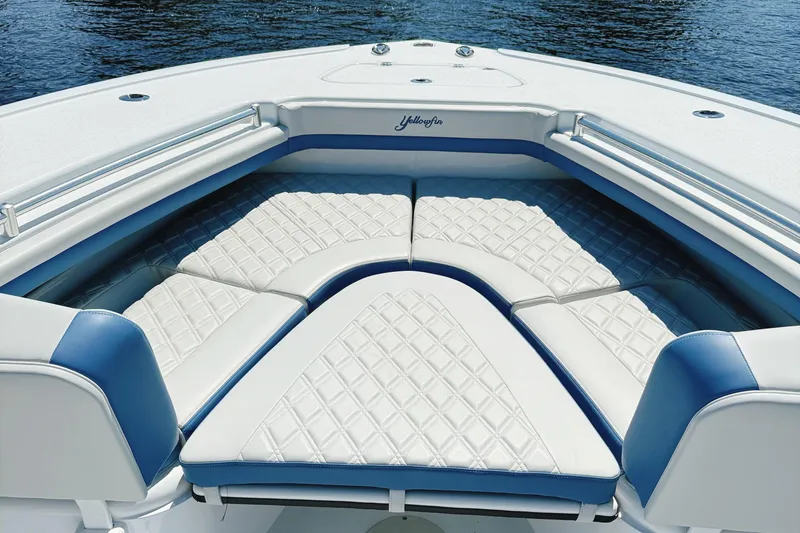 Slide: The Image of 2024 Yellowfin 34 Offshore boat seat with diamond-stitched upholstery and cup holders. - 34