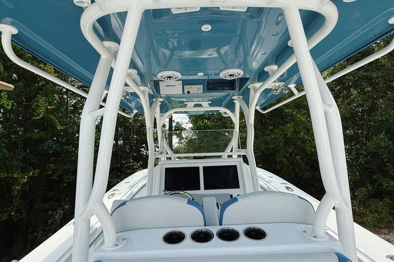 Slide: The Image of 2024 Yellowfin 34 Offshore boat docked, showcasing sleek design and spacious deck. - 8