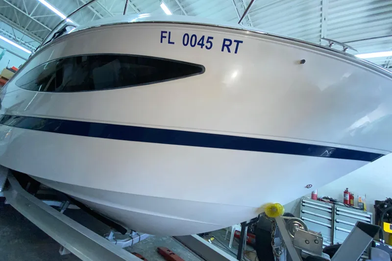 Slide: The Image of 2012 Four Winns V305 boat in a garage, registration FL 0045 RT. - 10