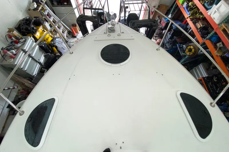Slide: The Image of 2012 Four Winns V305 boat deck in a storage area with equipment. - 12
