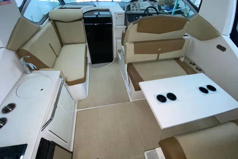 Slide: The Image of Interior of 2012 Four Winns V305 boat with seating, table, and kitchenette. - 16