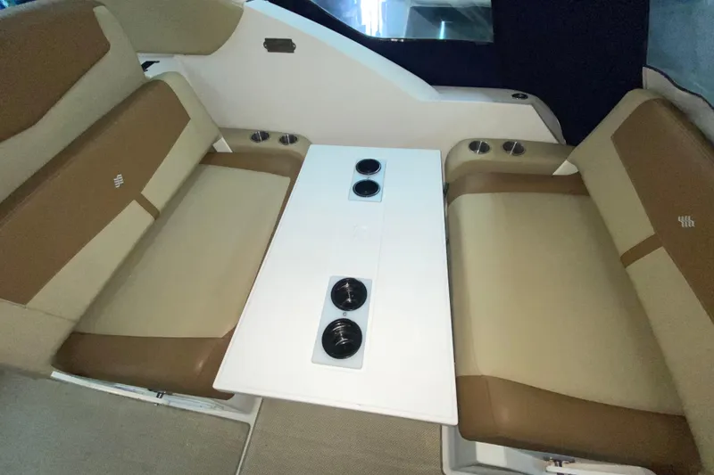 Slide: The Image of Interior seating of 2012 Four Winns V305 boat with table and cup holders. - 17
