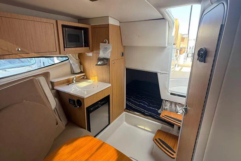 Slide: The Image of Interior of 2012 Four Winns V305 boat with kitchenette and sleeping area. - 25