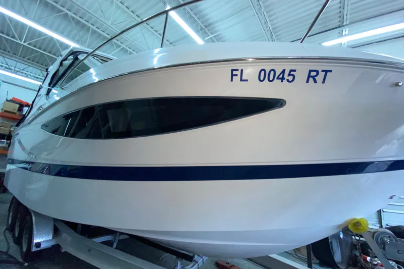 Slide: The Image of 2012 Four Winns V305 boat with registration FL 0045 RT in a garage. - 8