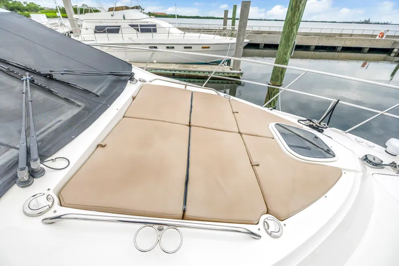 Slide: The Image of 2017 Sea Ray Sundancer 460 yacht with cushioned deck, docked at marina. - 11