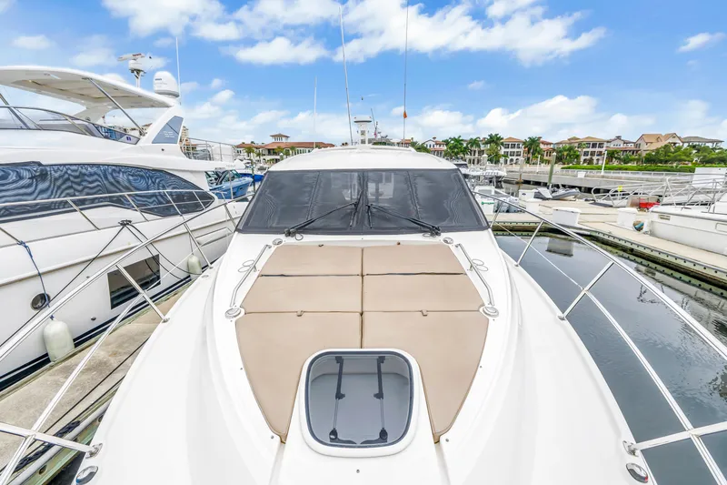 Slide: The Image of 2017 Sea Ray Sundancer 460 yacht docked at marina under blue sky. - 12