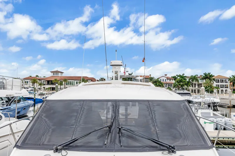 Slide: The Image of 2017 Sea Ray Sundancer 460 yacht docked at marina, with luxury waterfront homes in background. - 13