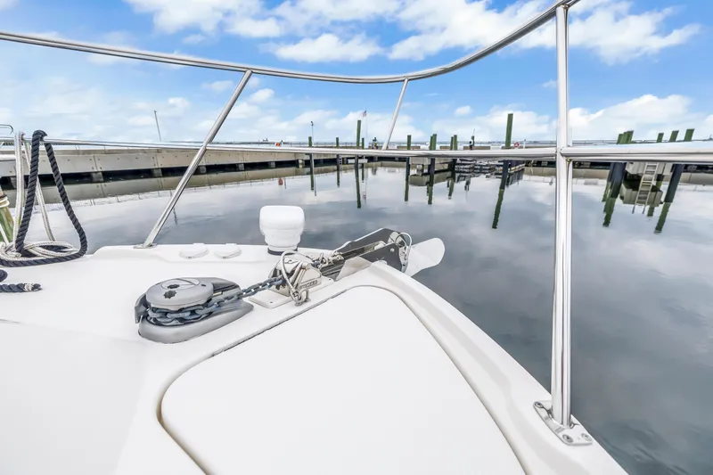 Slide: The Image of 2017 Sea Ray Sundancer 460 yacht bow at marina, calm water reflection. - 15