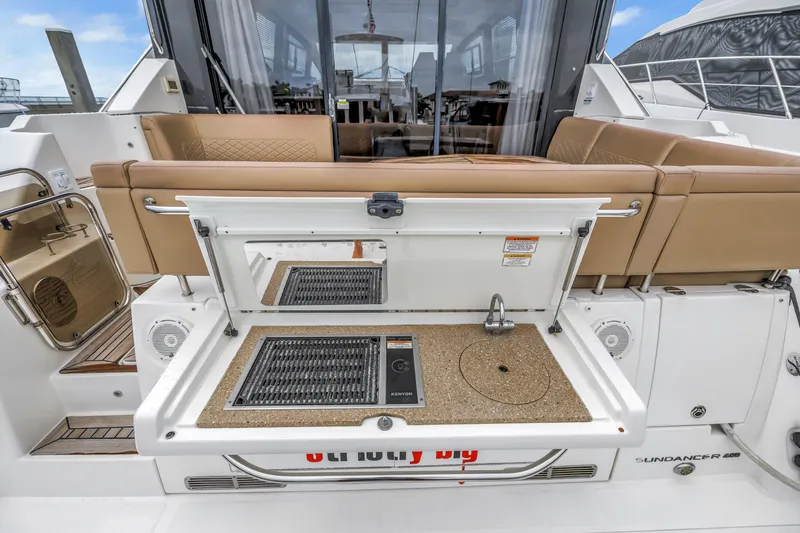Slide: The Image of 2017 Sea Ray Sundancer 460 yacht with outdoor kitchenette and seating area. - 19