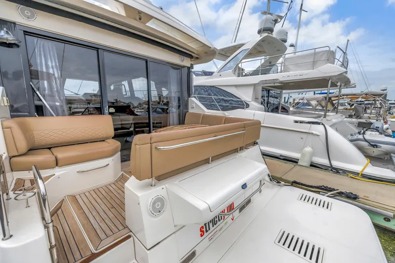 Slide: The Image of 2017 Sea Ray Sundancer 460 yacht with luxurious seating at a marina. - 20