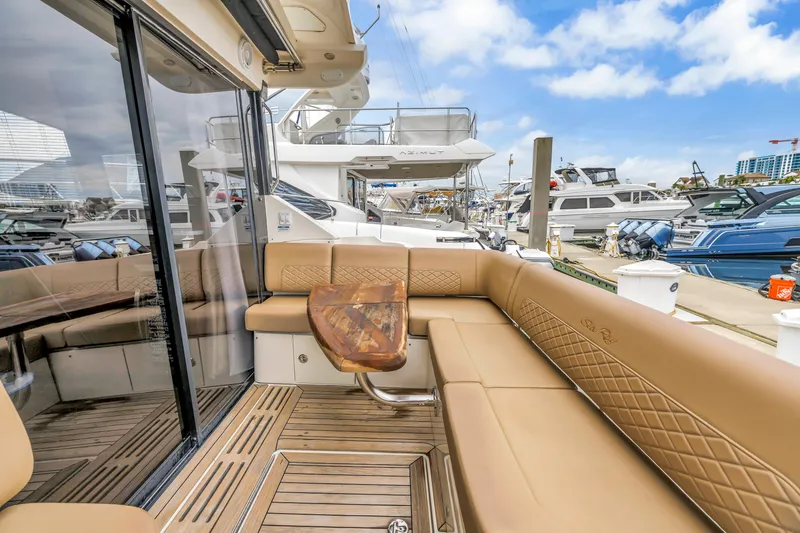 Slide: The Image of Luxurious 2017 Sea Ray Sundancer 460 yacht with elegant seating at a marina. - 23