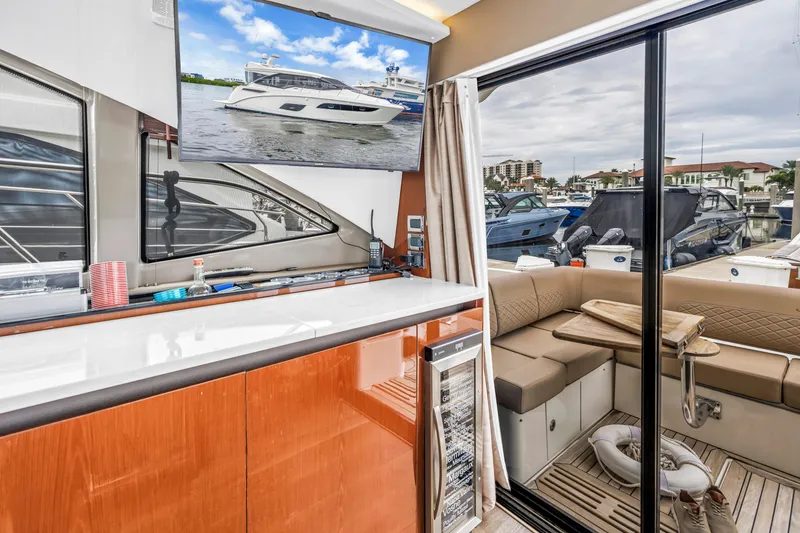 Slide: The Image of Interior of 2017 Sea Ray Sundancer 460 yacht with modern amenities and marina view. - 24