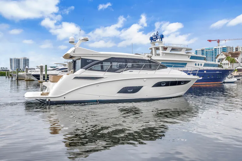 Slide: The Image of 2017 Sea Ray Sundancer 460 yacht docked in a marina under a blue sky. - 3