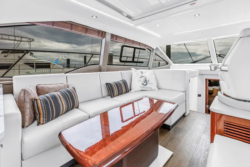 Slide: The Image of Luxurious interior of 2017 Sea Ray Sundancer 460 yacht with elegant seating and wooden table. - 31
