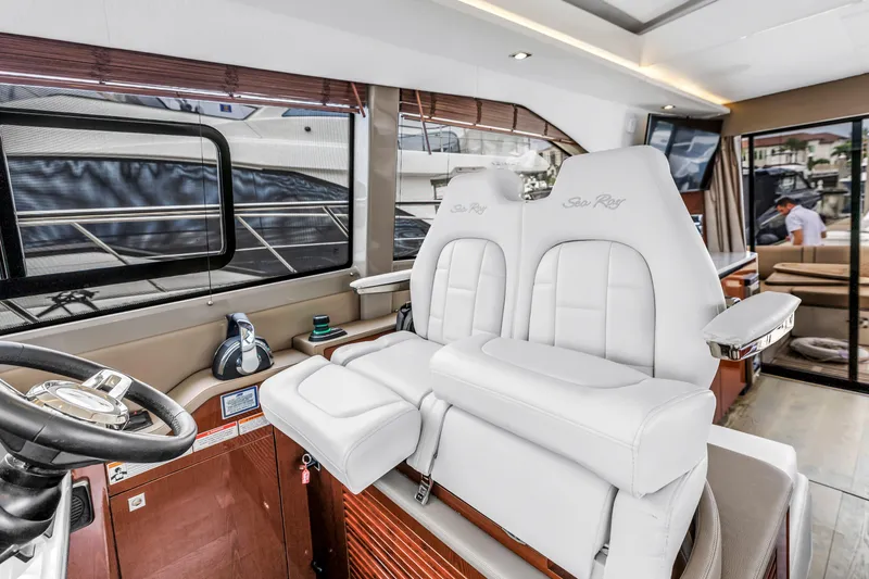 Slide: The Image of 2017 Sea Ray Sundancer 460 yacht interior with luxurious white seating and modern helm. - 32