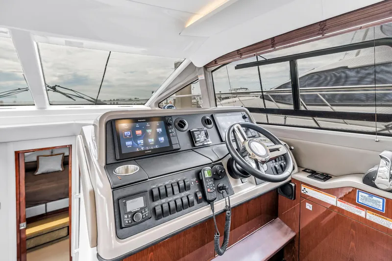 Slide: The Image of Helm of 2017 Sea Ray Sundancer 460 yacht with modern navigation controls. - 33